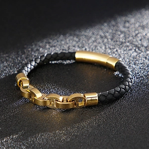 Macro view of black braided leather bracelet with gold-tone stainless steel link buckle