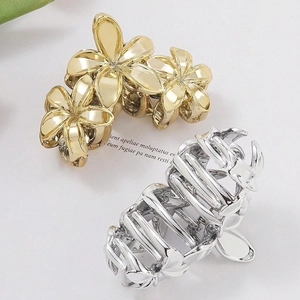 Elegant gold and silver metallic frangipani flower hair claws for women's updos