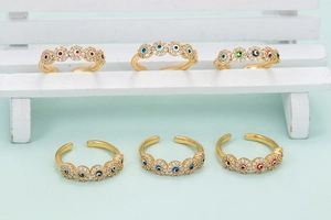 Detailed view of six colorful evil eye open rings with gold plating and zircons
