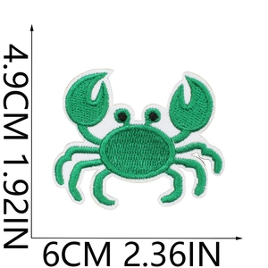 Macro view of green crab embroidered patch showing texture and precise dimension details