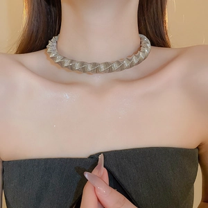 Detailed view of silver metallic choker with intricate twisted spiral texture on model