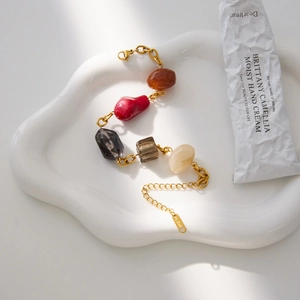 Detailed shot of retro resin bead bracelet with gold stainless steel chain on tray