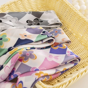 Floral geometric silk-like square scarf set in various colors inside a woven basket