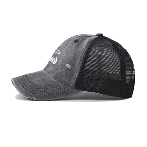Detailed view of Blessed embroidery on washed denim mesh baseball cap with distressed details