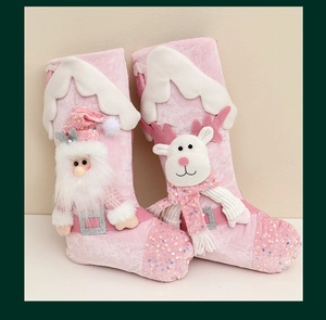 Close-up of pink sequins and 3D Santa and reindeer figures on plush Christmas stockings