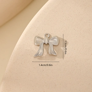 Detailed view of silver bow-knot zircon pendant with 1.5cm x 1.4cm dimensions
