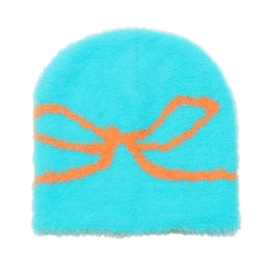 Close-up of the plush knit texture and orange bow jacquard on the blue beanie hat