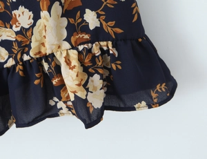 Detailed view of floral chiffon fabric with ruffled edges and retro flower patterns