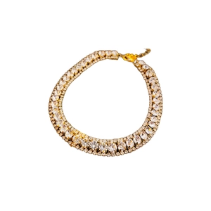 Elegant gold choker necklace featuring oval and round cut rhinestones on a white background