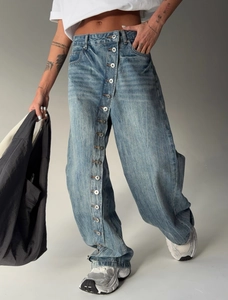 Retro washed wide leg jeans with asymmetrical multi-button closure and high waist fit