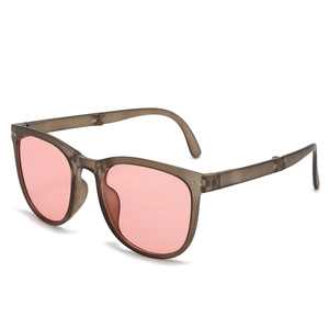 Foldable pink lens sunglasses with gray translucent frame shown from a 45-degree angle