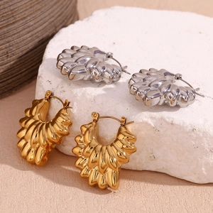 Detailed view of layered hollow petal earrings with 18K gold and silver ripple textures