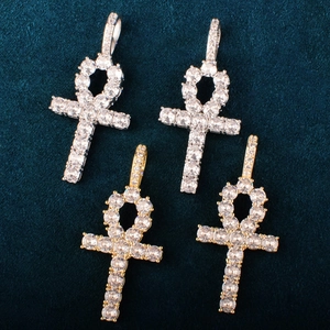 Detailed view of gold and silver Ankh cross pendants with sparkling cubic zirconia stones