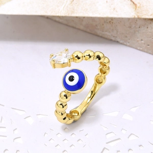 Golden Evil Eye open ring with blue enamel and pear-shaped zircon on a beaded band