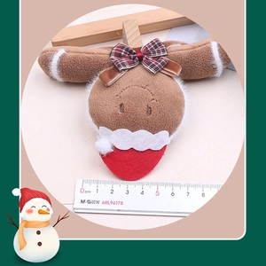 Detailed plush reindeer hair clip with festive bow and 8cm scale reference guide