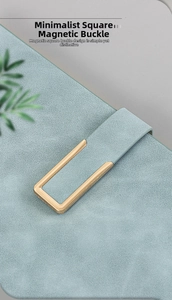 Detail of minimalist rectangular gold magnetic buckle on A5 textured leather notebook