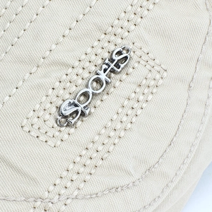 Classic beige sports newsboy cap with metal lettering and retro canvas material