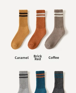 Detailed texture of ribbed wool socks in caramel and coffee colors with striped cuffs