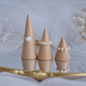 Elegant 14k gold plated natural freshwater pearl rings set on wooden display stands