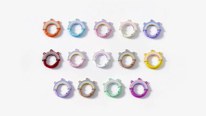 Macro display of colorful rainbow spring rings in various matte macaron shades