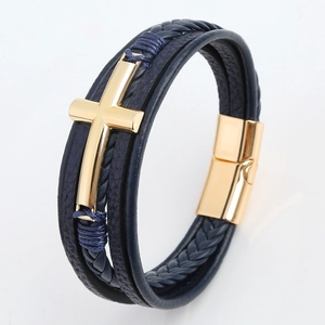 Detailed macro view of men's leather bracelet with golden cross and magnetic buckle