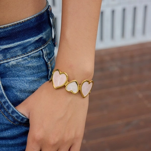 18K gold stainless steel open cuff bracelet with pink marble heart charms on wrist
