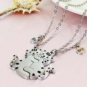 Minimalist BFF necklaces featuring two silver cats hugging with small round BFF charms
