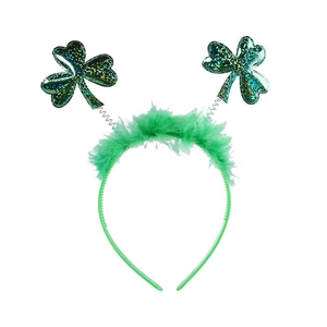Close-up of St. Patrick's Day green headband with sequined clovers and feather trim