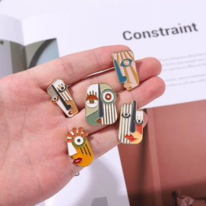 Set of five abstract face enamel pins in surrealist art style for bags and clothing