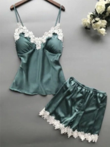 Detailed view of dark green satin pajama set with elegant white lace trimmings and V-neck