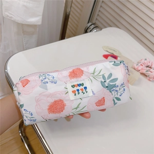 Detailed shot of floral cotton stationery bag with zipper and best woven label