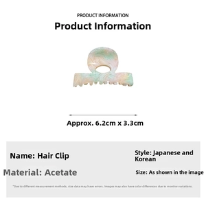 Detail of acetate hair claw clip with marble texture measuring 6.2cm by 3.3cm