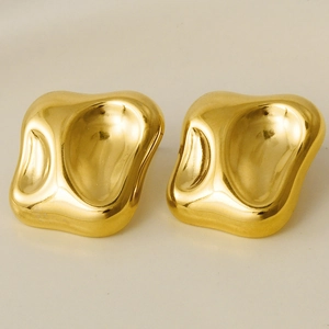 Macro shot of 18k gold irregular geometric earrings with polished concave texture