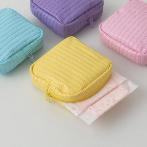 Close-up of quilted leather makeup pouch storage showing textured finish and metal zipper