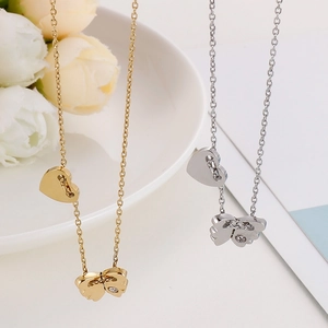 Close-up of gold and silver butterfly and heart pendant necklaces with small crystal
