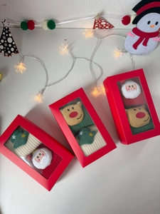 Detailed view of Christmas cotton socks gift box with festive Santa and reindeer 3D patches