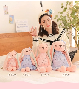 Four sizes of cute pink and blue long-eared rabbit plush toys shown with a female model