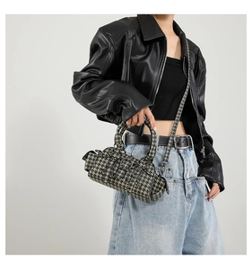 Detail of Boston bag showing retro pattern with metal buckles and detachable strap
