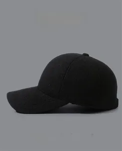 Close-up of wool baseball cap with metallic MR logo detail and thick warm fabric
