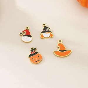 Detail of four gold Halloween charms with colorful enamel ghosts and pumpkin shapes