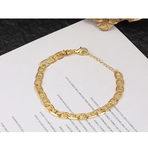 Detailed view of a gold pig-nose anchor chain bracelet with adjustable lobster clasp