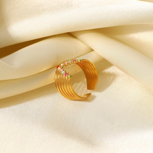Detail of 18K gold plated multi-layer ring with colorful enamel dots on satin