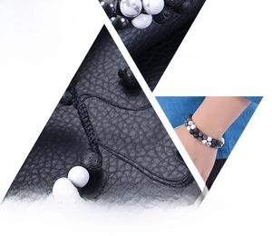 Detail von 8mm Lavastein und weißem Türkis-Perlenarmband auf schwarzem Ledergrund