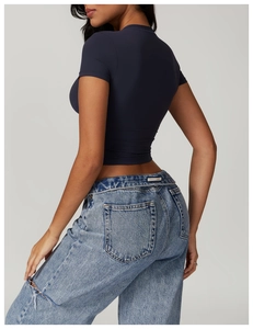 Side view of slim fit quick-dry sports t-shirt paired with high waist jeans