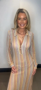 Detail of colorful crochet knit patterns on long sleeve V-neck beach maxi dress
