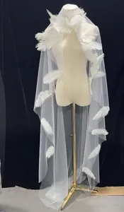 Detail of white bridal wedding veil with delicate feathers and mesh material texture