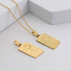 Macro view of a gold-plated Aquarius rectangular pendant necklace made of stainless steel