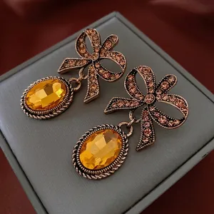 Vintage bronze bow earrings with crystal pavé and large amber gemstone drops