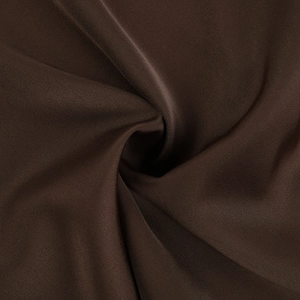 Detail shot of deep brown silky satin fabric with elegant spiral draping and texture