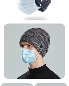Detail of dark grey knit beanie with side buttons for mask attachment and warm texture